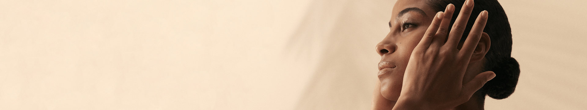 kama model with her hands on her face